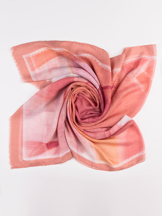 Folded pink and orange scarf on a white background