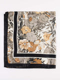 Floral patterned scarf with black border on a white background